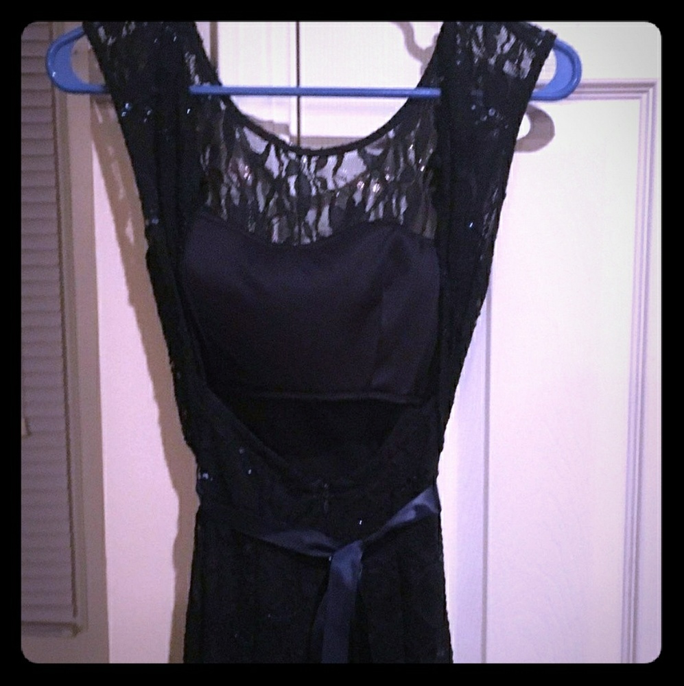 This is a dark navy blue sequined formal dress.
